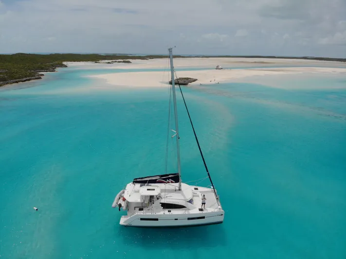 Second Treasure II Yacht Photos Pics Leopard 40 catamaran sailing in turquoise waters near a sandy beach, 2020 model.