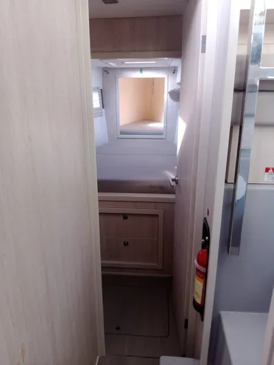 Second Treasure II Yacht Photos Pics Interior cabin of a 2020 Leopard 40 catamaran, featuring a cozy bed and storage.