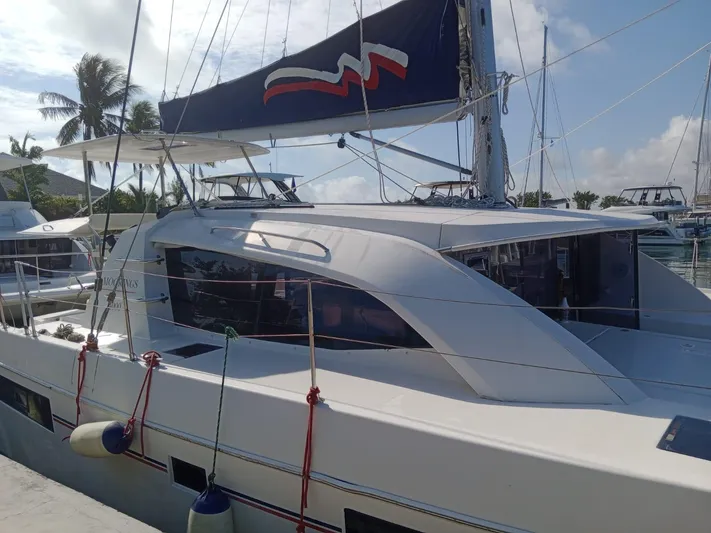Second Treasure II Yacht Photos Pics Leopard 40 catamaran docked, 2020 model, with sails and tropical backdrop.