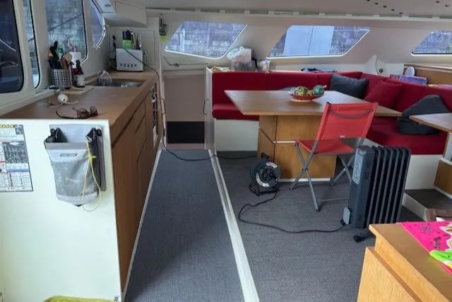 Obi One Yacht Photos Pics Interior of 2009 Catamaran Trimarine Carrera 57 with kitchen and seating area.