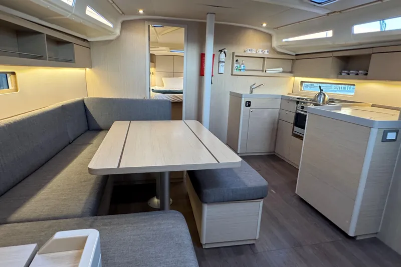 Madras Yacht Photos Pics Modern interior of 2022 Beneteau Oceanis 40.1 yacht with kitchen and dining area.