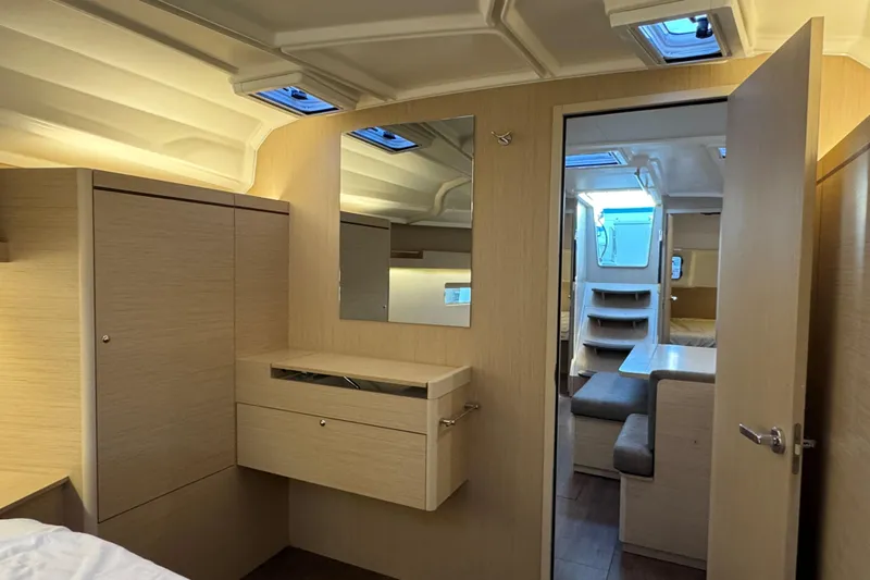 Madras Yacht Photos Pics Interior of 2022 Beneteau Oceanis 40.1 yacht, featuring modern wood cabinetry and seating.