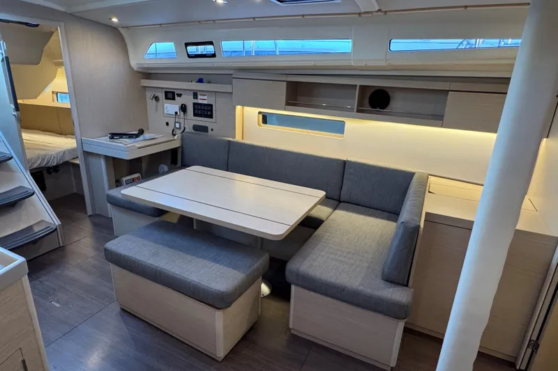 Madras Yacht Photos Pics Modern interior of 2022 Beneteau Oceanis 40.1 yacht with cozy seating and dining area.