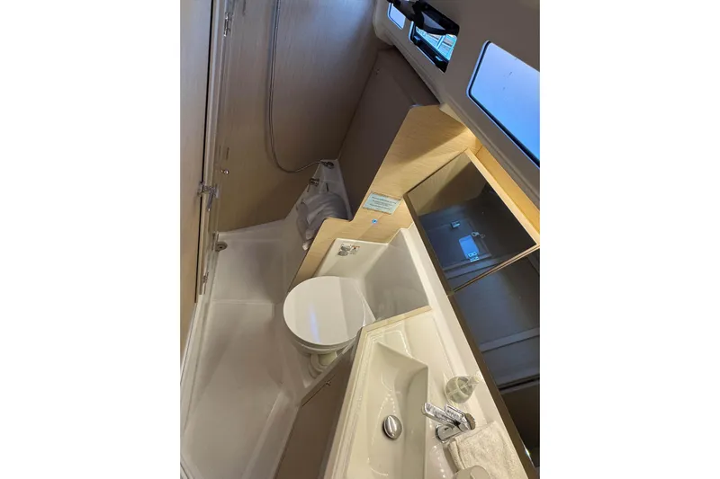 Madras Yacht Photos Pics Modern bathroom in 2022 Beneteau Oceanis 40.1 yacht, featuring sleek fixtures and ample lighting.