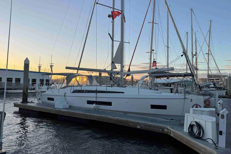 Madras Yacht Photos Pics 2022 Beneteau Oceanis 40.1 sailboat docked at marina during sunset.