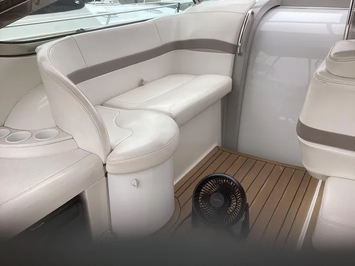 Four-some Fun Yacht Photos Pics 2001 Formula 40 PC boat interior with white leather seating and wooden flooring.