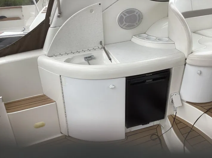 Four-some Fun Yacht Photos Pics 2001 Formula 40 PC yacht interior with sink, mini-fridge, and cup holders.