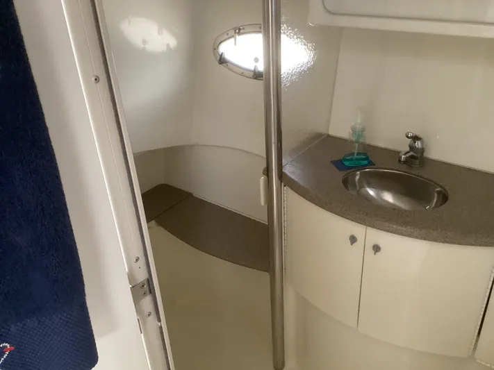 Four-some Fun Yacht Photos Pics 2001 Formula 40 PC boat bathroom with sink, mirror, and porthole window.