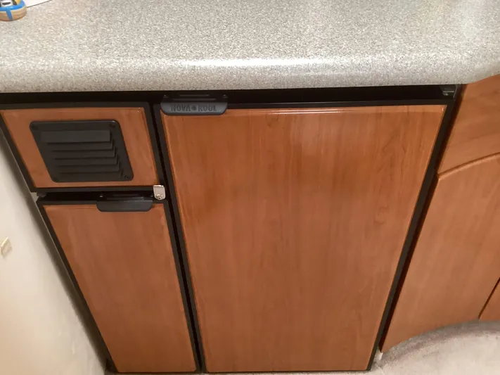 Four-some Fun Yacht Photos Pics Wooden cabinetry and countertop in a 2001 Formula 40 PC boat kitchen.