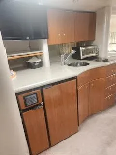 Four-some Fun Yacht Photos Pics 2001 Formula 40 PC yacht kitchen with modern appliances and wooden cabinetry.