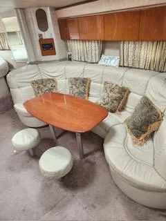 Four-some Fun Yacht Photos Pics 2001 Formula 40 PC yacht interior with leather seating and wooden table.