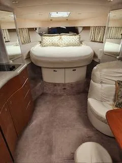 Four-some Fun Yacht Photos Pics Interior of a 2001 Formula 40 PC yacht with a cozy bedroom and seating area.