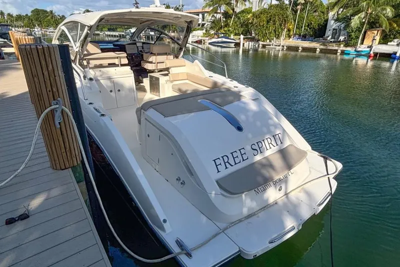  Yacht Photos Pics 2014 Pursuit SC 365i Sport Coupe docked, named "Free Spirit," in a serene marina setting.