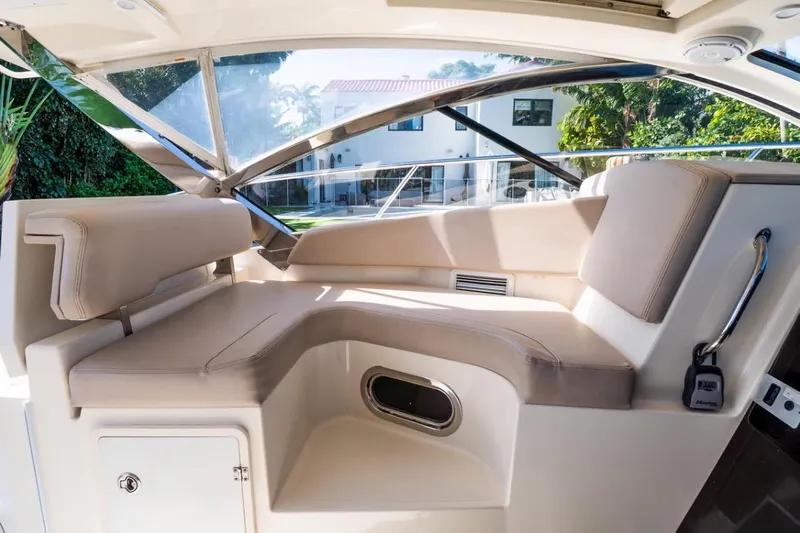  Yacht Photos Pics Luxurious interior of 2014 Pursuit SC 365i Sport Coupe with beige seating and modern design.