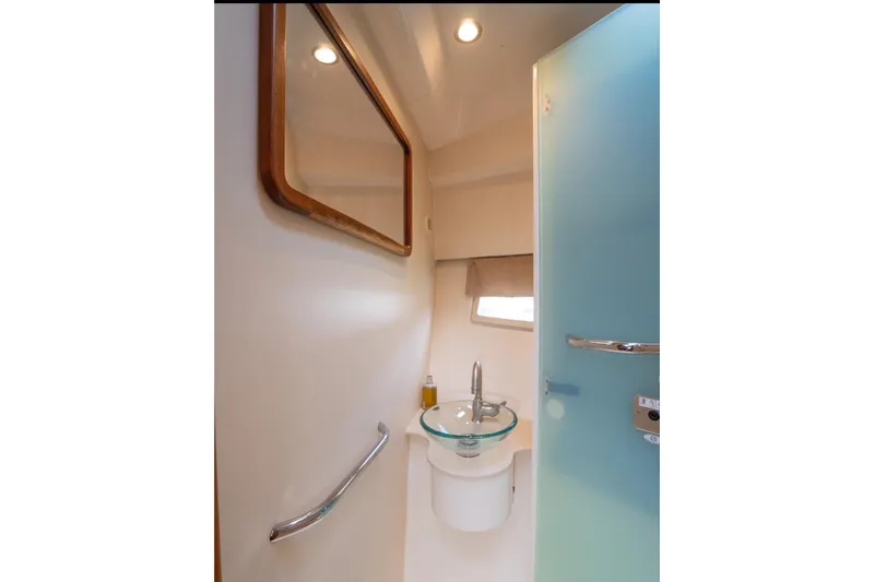  Yacht Photos Pics 2014 Pursuit SC 365i Sport Coupe bathroom with modern sink and mirror.