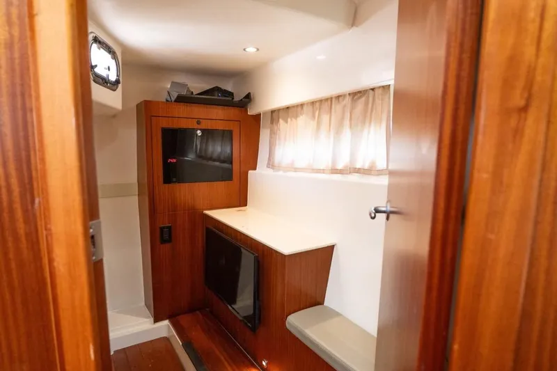  Yacht Photos Pics Interior of 2014 Pursuit SC 365i Sport Coupe with wood paneling and seating.