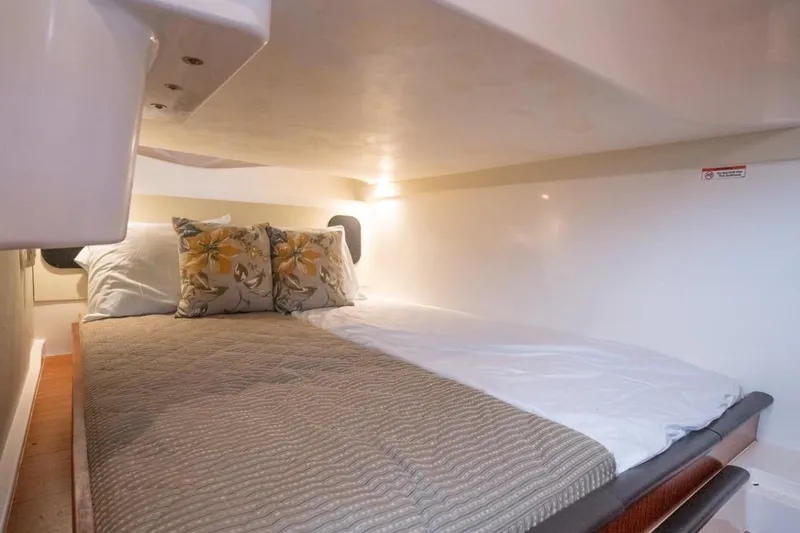  Yacht Photos Pics 2014 Pursuit SC 365i Sport Coupe cabin with cozy bed and floral pillows.