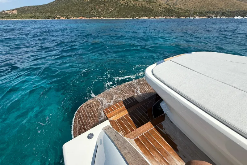  Yacht Photos Pics 2022 Solaris Power 44 Open yacht on clear blue water, wooden deck visible.