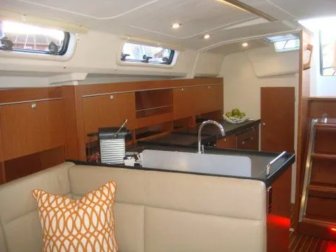 Bonejour Yacht Photos Pics Interior of 2012 Hanse 385 yacht with modern kitchen and seating area.