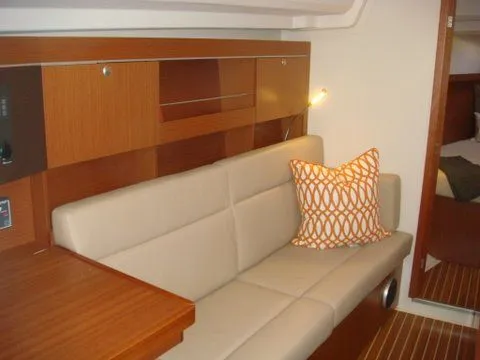 Bonejour Yacht Photos Pics Interior of 2012 Hanse 385 yacht with beige seating and decorative pillow.