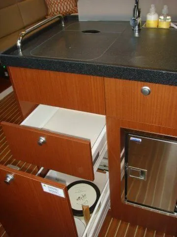 Bonejour Yacht Photos Pics Hanse 385 2012 yacht kitchen with wooden cabinets and modern appliances.