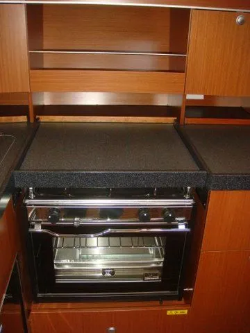 Bonejour Yacht Photos Pics Hanse 385 2012 yacht kitchen with modern oven and wooden cabinetry.