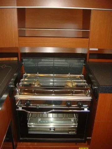 Bonejour Yacht Photos Pics Modern kitchen in 2012 Hanse 385 yacht with stove and wooden cabinetry.