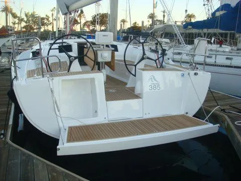 Bonejour Yacht Photos Pics 2012 Hanse 385 sailboat docked at marina, featuring dual steering wheels.