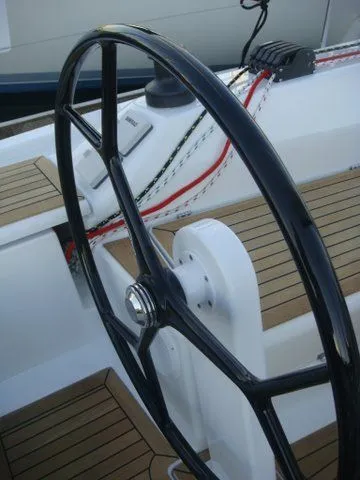 Bonejour Yacht Photos Pics Steering wheel of a 2012 Hanse 385 sailboat with teak decking.