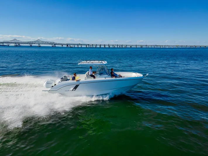  Yacht Photos Pics 2025 Beneteau Flyer 9 SPACEdeck cruising on open water near a bridge.