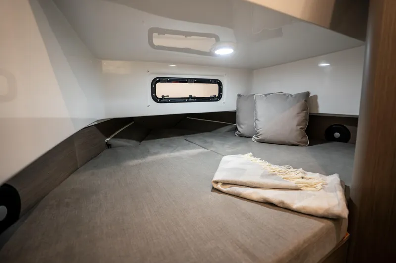  Yacht Photos Pics 2025 Beneteau Flyer 9 SPACEdeck cabin interior with cozy bedding and window.