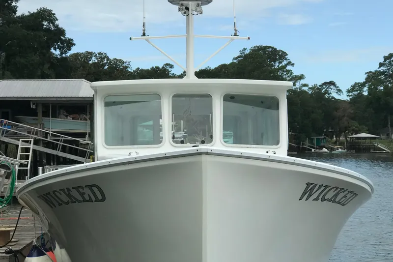  Yacht Photos Pics 2015 Wesmac Sport Fish boat docked, front view with "Wicked" name visible.