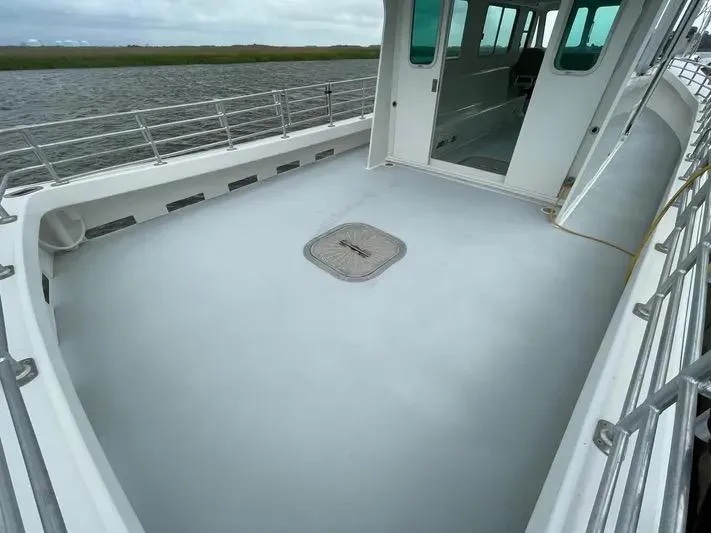  Yacht Photos Pics 2015 Wesmac Sport Fish boat deck with railing, open cabin, and water view.