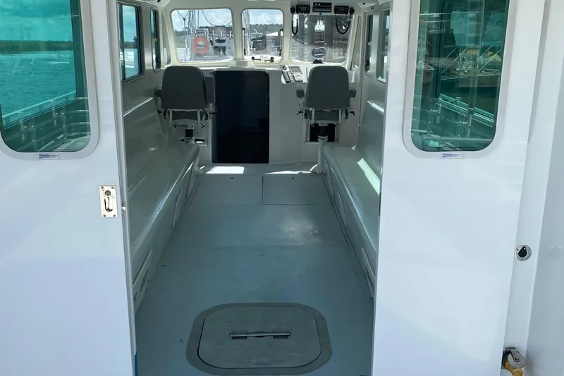  Yacht Photos Pics 2015 Wesmac Sport Fish interior with seating, windows, and open cabin view.