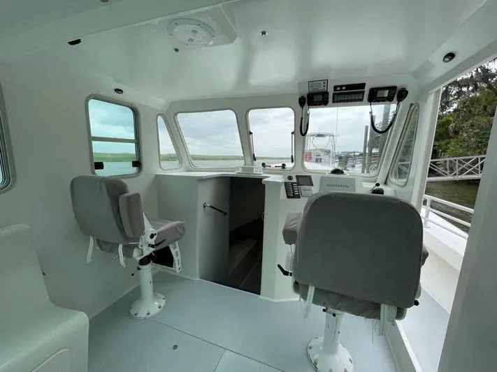  Yacht Photos Pics Interior of 2015 Wesmac Sport Fish boat with helm and seating.