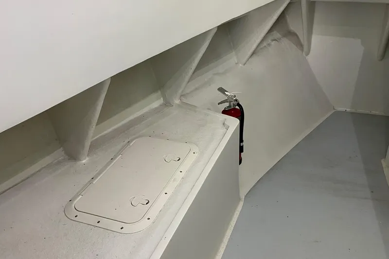 Yacht Photos Pics 2015 Wesmac Sport Fish interior with storage hatch and fire extinguisher.