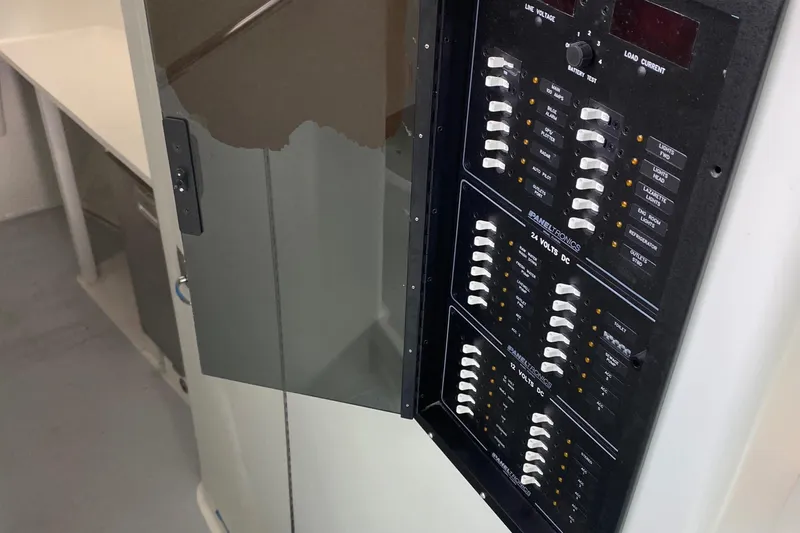  Yacht Photos Pics Electrical panel inside a 2015 Wesmac Sport Fish boat, showcasing circuit breakers.