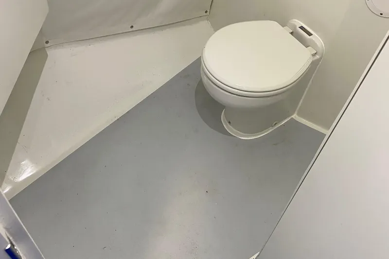  Yacht Photos Pics 2015 Wesmac Sport Fish boat bathroom with white toilet and clean interior.