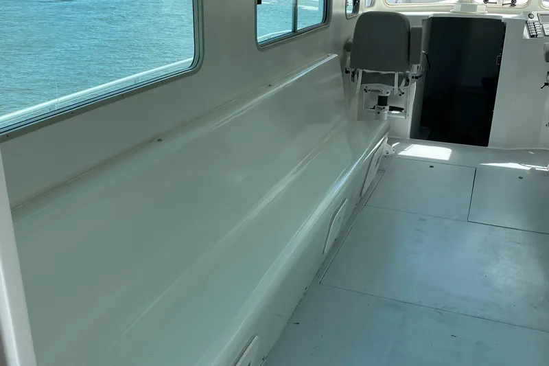  Yacht Photos Pics 2015 Wesmac Sport Fish boat interior with seating and windows overlooking the water.