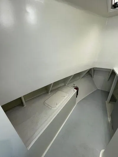  Yacht Photos Pics 2015 Wesmac Sport Fish interior with clean, white storage area and sleek design.