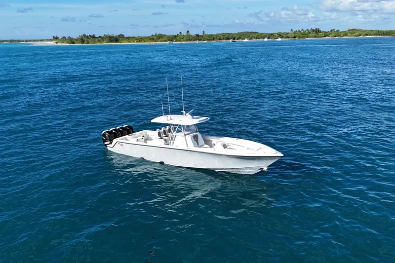  Yacht Photos Pics 2020 SeaVee 390Z boat on blue ocean near lush green coastline.