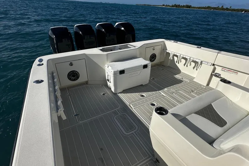  Yacht Photos Pics 2020 SeaVee 390Z boat deck with cooler, ocean backdrop, and multiple outboard engines.