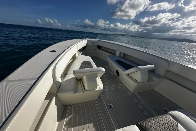  Yacht Photos Pics 2020 SeaVee 390Z boat interior with cushioned seating, ocean view, and clear sky.