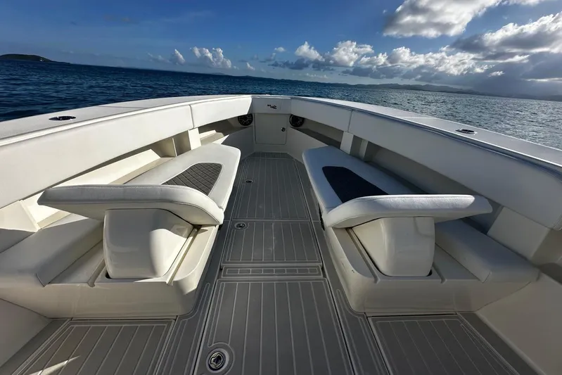  Yacht Photos Pics 2020 SeaVee 390Z boat interior with cushioned seating, ocean view, and clear sky.