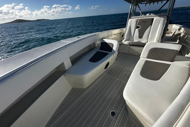  Yacht Photos Pics 2020 SeaVee 390Z boat interior with cushioned seating, ocean view, and clear skies.