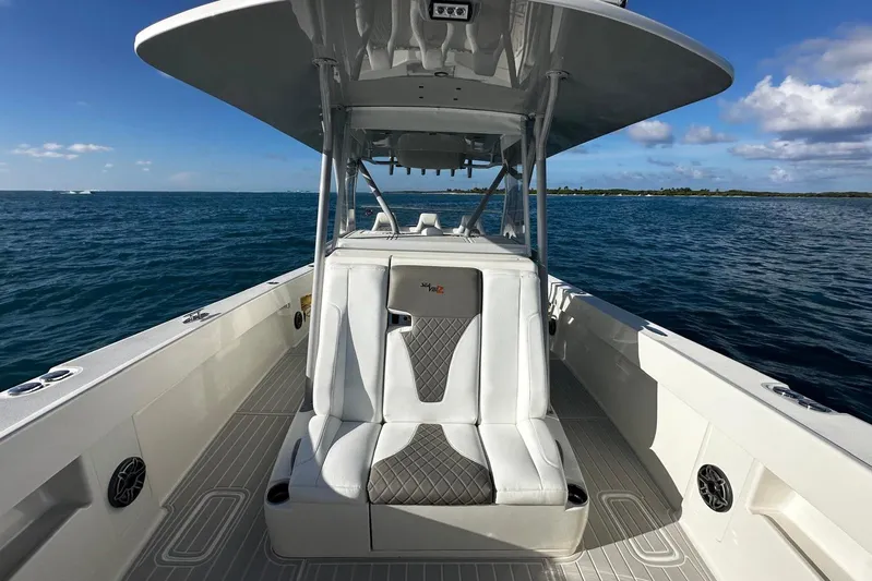  Yacht Photos Pics 2020 SeaVee 390Z boat interior with cushioned seating, ocean view, and clear sky.
