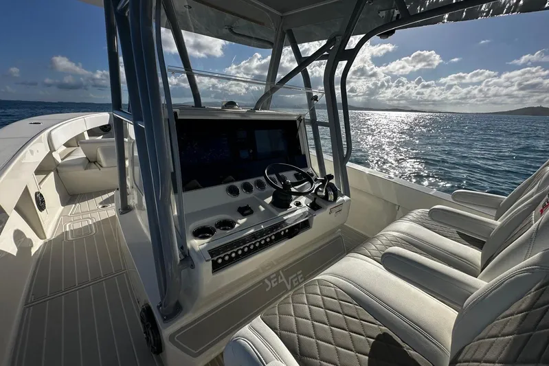  Yacht Photos Pics 2020 SeaVee 390Z boat interior with helm, ocean view, and cushioned seating.