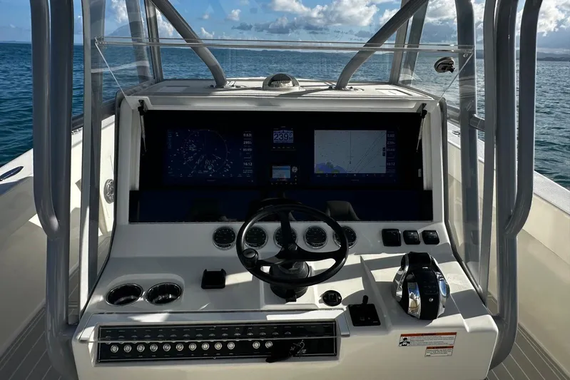  Yacht Photos Pics 2020 SeaVee 390Z boat dashboard with navigation screens and steering wheel on open water.