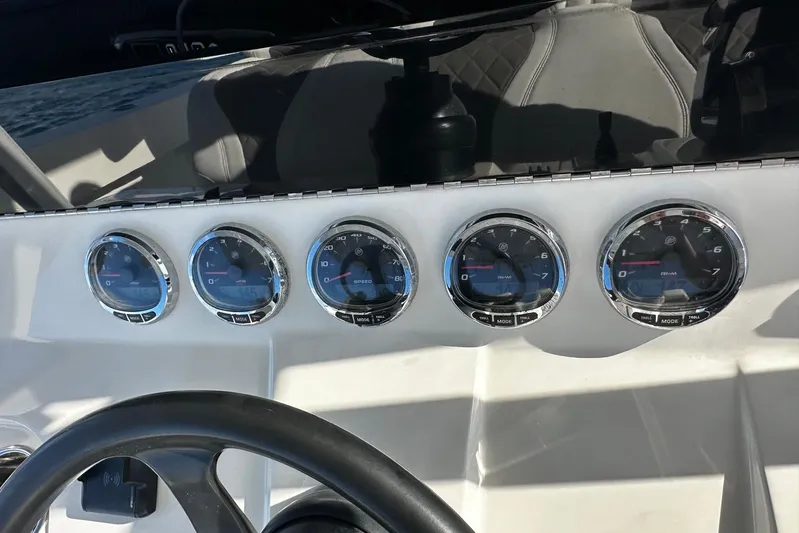  Yacht Photos Pics Dashboard of 2020 SeaVee 390Z boat with five gauges and steering wheel.