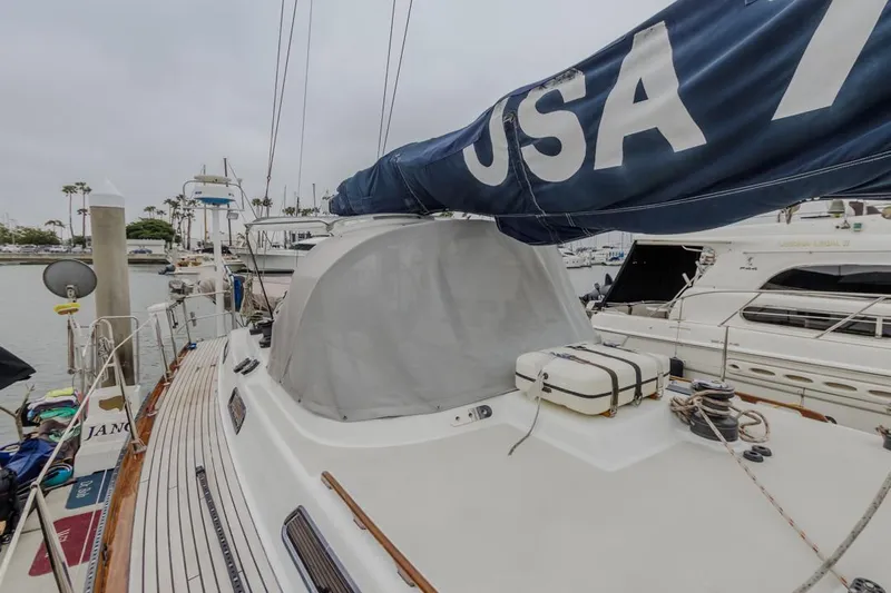 Jano Yacht Photos Pics Farr 55 sailboat from 1994 docked in a marina, featuring a blue sail.